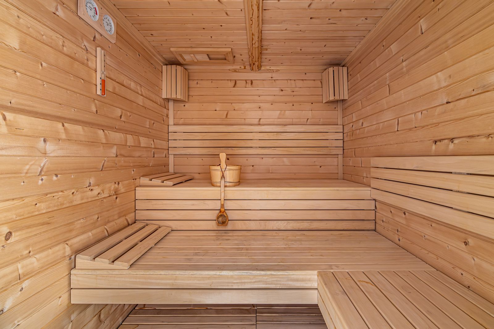Wooden sauna with benches on two levels