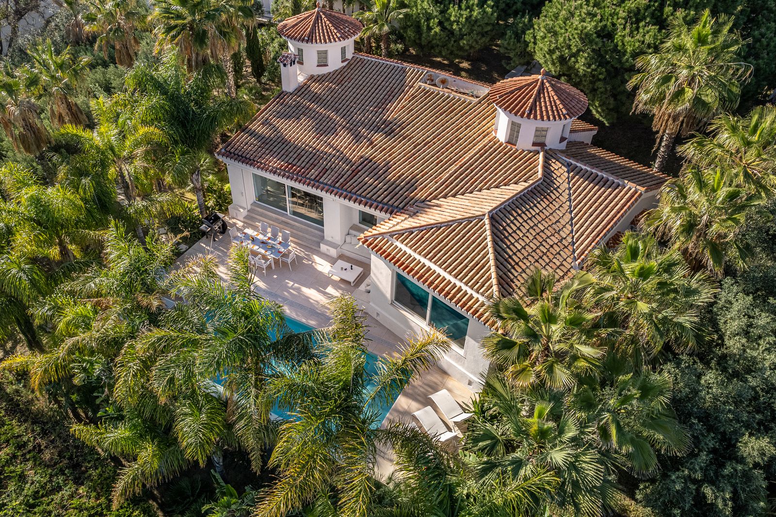 Aerial view of the terracotta roofs, private pool and palm garden